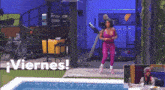 a woman in a pink jumpsuit is standing in front of a pool with the words viernes written on the bottom
