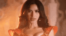a woman in a red dress is looking at the camera .