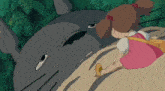 a little girl in a pink dress is sitting next to a large gray animal