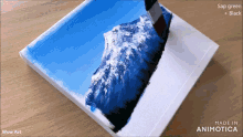 a painting of a mountain is being painted in sap green and black