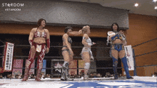 a group of women standing in a wrestling ring with the word stardom on the bottom