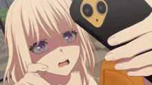 a girl with purple eyes is taking a picture of herself with her phone