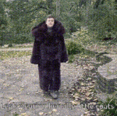 a man wearing a fur coat with the caption leah wearing her silly little coat
