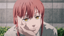 a girl with red hair and yellow eyes is smiling with her hand on her face