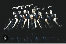 a group of people are standing in a row with a black background