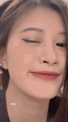 a close up of a woman 's face with her eyes closed and red lips .