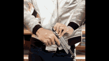 a man in a white jacket holds a gun in his hand
