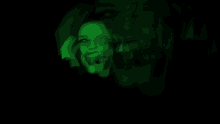 a woman is making a funny face in the dark with green lights behind her