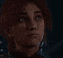 a close up of a woman 's face with a dark background