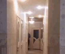 a hallway with a ceiling fan and a door
