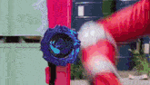 a person is holding a blue object that looks like a watch