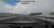 a black and white photo of a highway with the words bardzo mocno placesz drogo ekspresowo