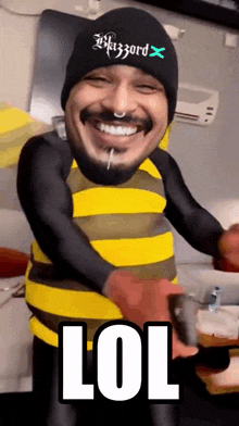 a man wearing a bee costume is smiling and holding a cup with lol written on it