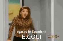 a woman is standing in a doorway with her mouth open and screaming in spanish .