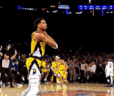 a basketball player in a yellow jersey with the number 2 on his shorts