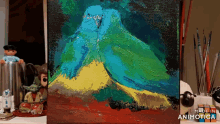 a painting of a blue and yellow bird is being made by animatica