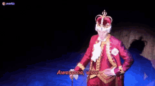 a man in a king 's costume is standing on a stage with a sword and crown .