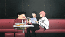 a man sitting at a table with a magazine that says jojo