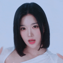 a woman with short black hair is making a peace sign with her fingers