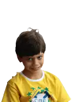 a young boy wears a yellow shirt with the word cre on it
