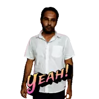 a man wearing a white shirt with the word yeah written on it