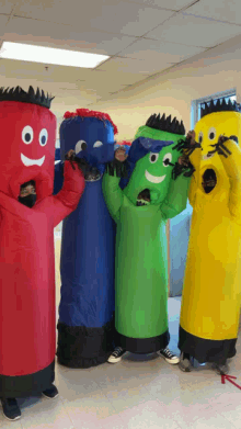 a group of people are dressed up in inflatable costumes