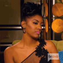 a woman sitting on a couch with the word bravo on the bottom right