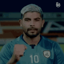 a soccer player wearing a blue shirt with the number 10 on it