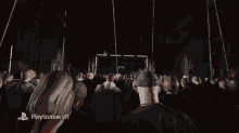 a crowd of people watching a video on a screen that says " playstation vr "