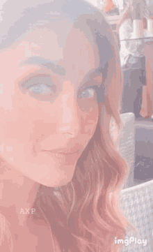 a close up of a woman 's face with the word axp on the bottom