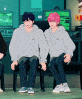 two anime characters are sitting next to each other in front of a computer screen