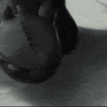 a black and white photo of a person 's face and neck