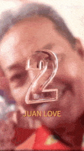 a close up of a man with the number 2 juan love