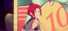 a boy with red hair and green eyes is standing in front of a sign that says 10 .