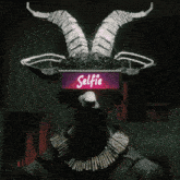 a person with horns and a selfie sign