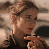 a woman with red lips is holding a man 's hand in front of her face
