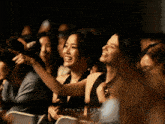 a group of people sitting in a dark room with the words filmatrice written on the bottom