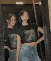 two girls are standing in front of a mirror with one wearing a shirt that says ' swirl '