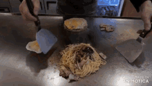 a person is cooking noodles and eggs on a stove with the words made in animatica visible