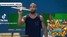 a man in a tank top is holding a toy airplane in his hand ..