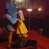 a man and a woman are dancing in a room
