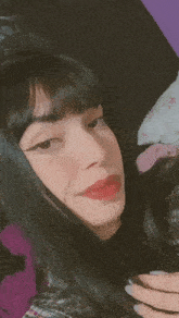 a close up of a woman 's face with red lips