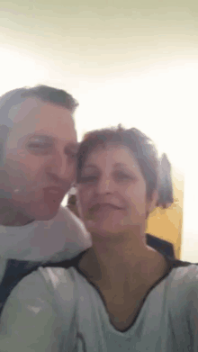 a man and a woman pose for a picture together