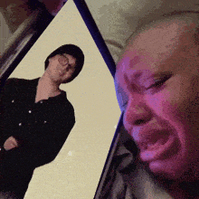 a person is crying while looking at a picture of a man