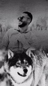 a black and white photo of a man and a wolf with the word liberty in the background