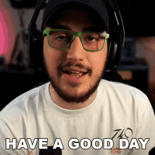a man wearing glasses and headphones is saying have a good day