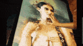 a painting of a woman with a crown on her head is being touched