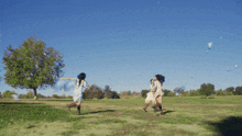 a woman in a white dress is running in a field