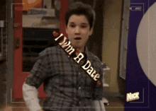 a man is standing in front of a sign that says nick