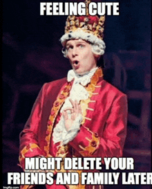 a man in a red suit and crown is making a funny face while wearing a crown .